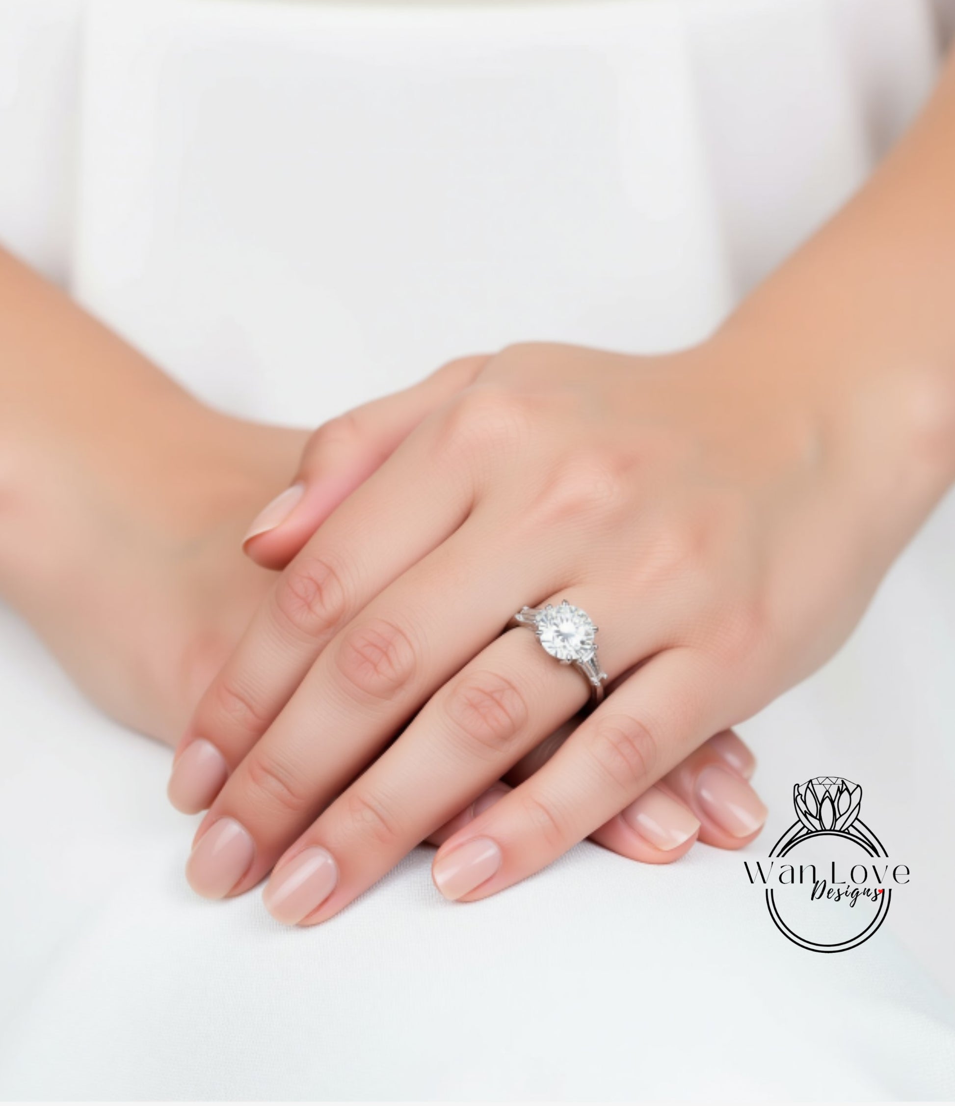 A close-up image of a person's hands wearing a diamond engagement ring.