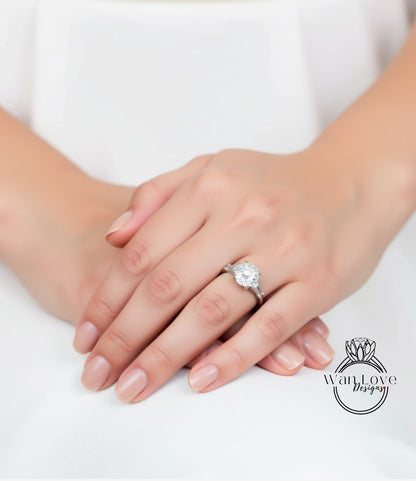 A close-up image of a person's hands wearing a diamond engagement ring.