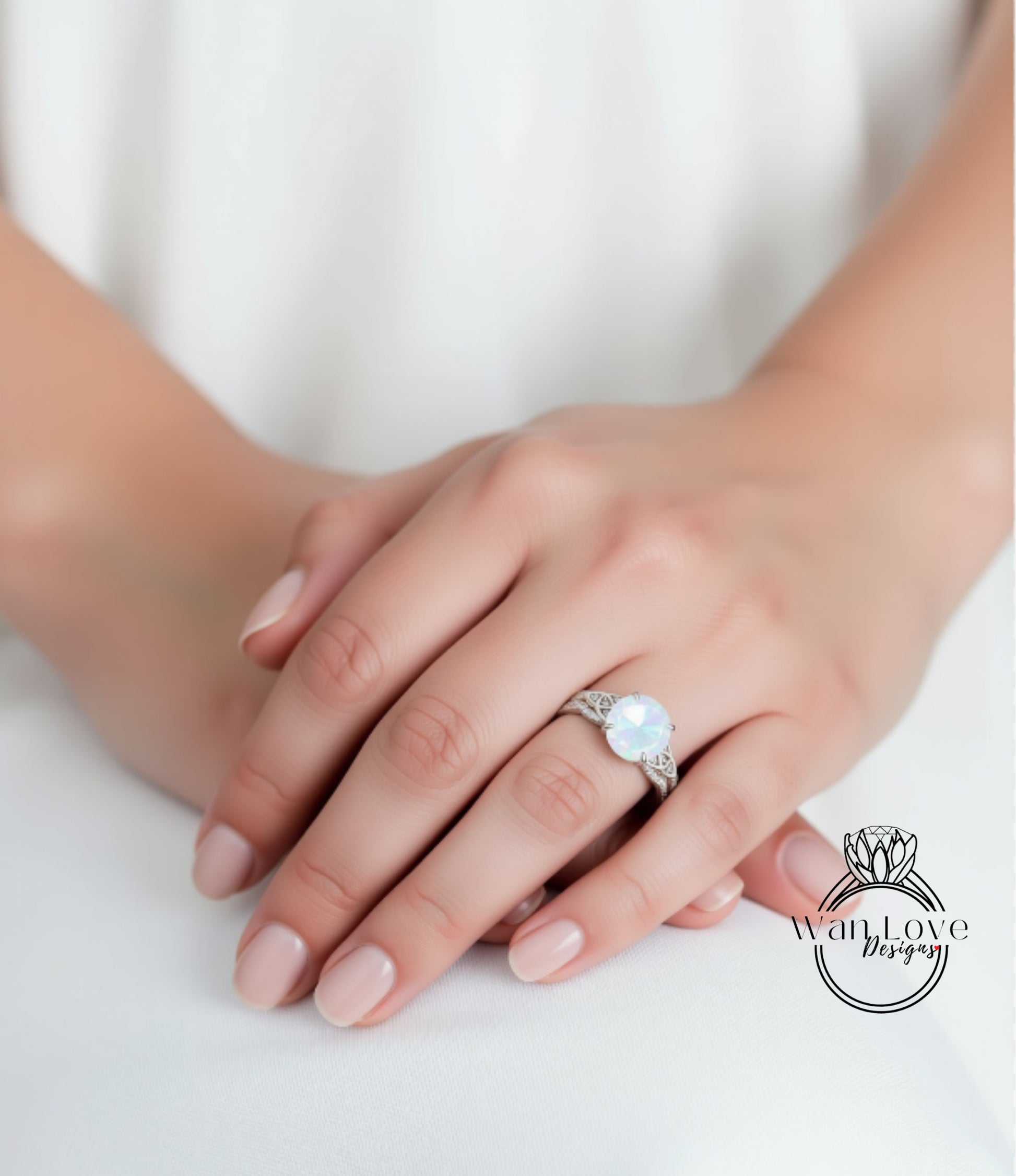 A close-up of a person's hand wearing a ring with a large, round gemstone.