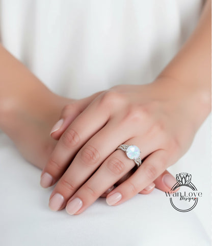 A close-up of a person's hand wearing a ring with a large, round gemstone.