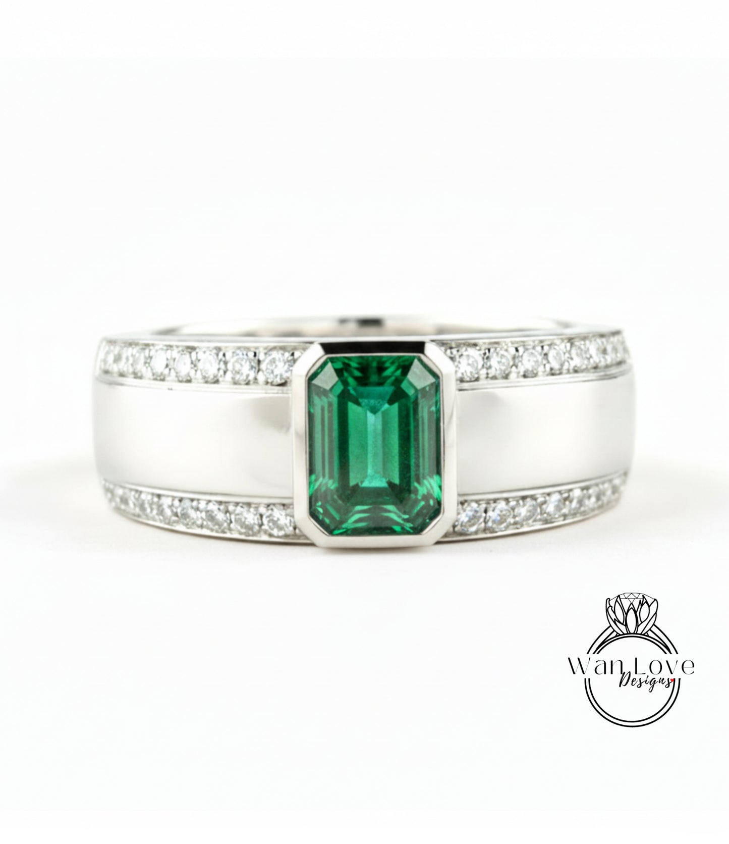A silver ring with a large green gemstone in the center, surrounded by smaller diamonds.