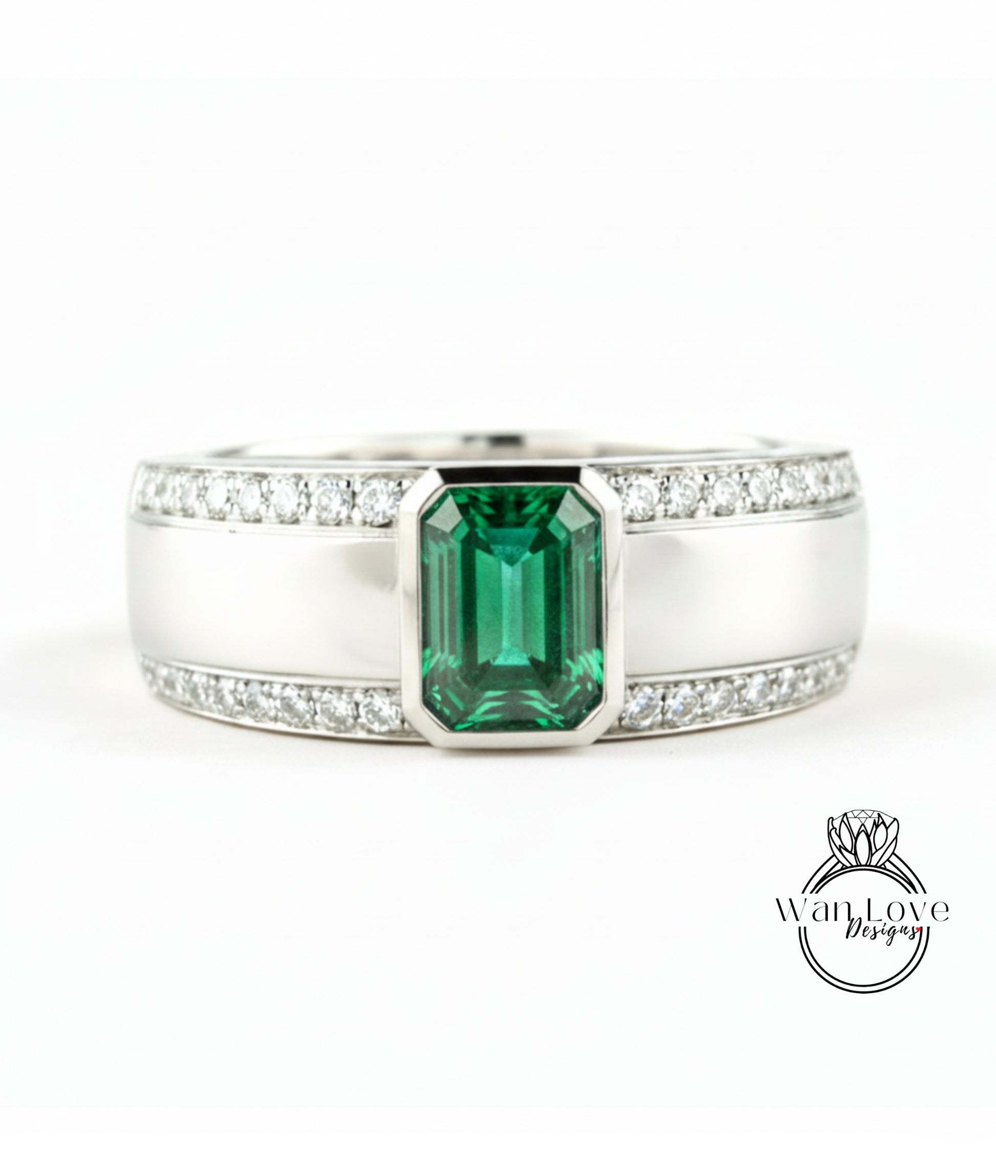 A silver ring with a large green gemstone in the center, surrounded by smaller diamonds.