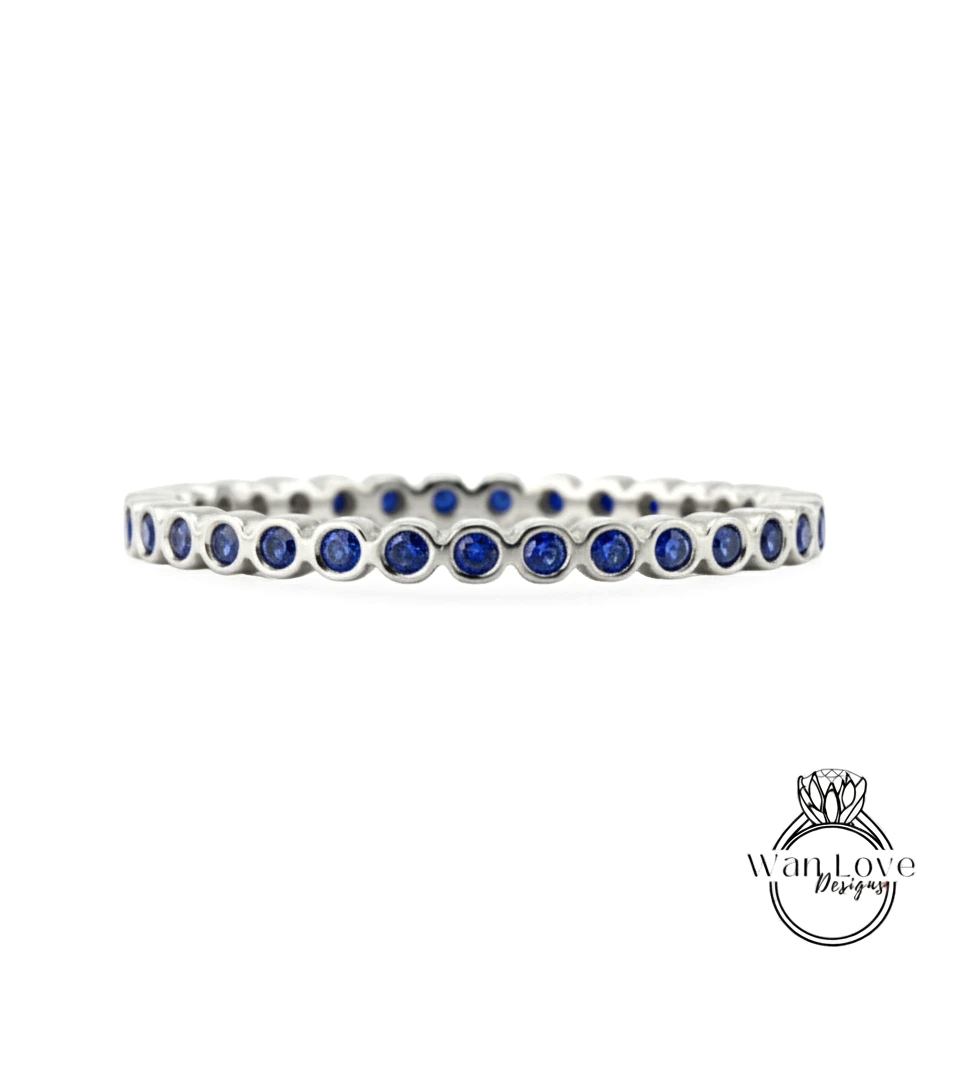 A silver bracelet with blue gemstones arranged in a circular pattern.
