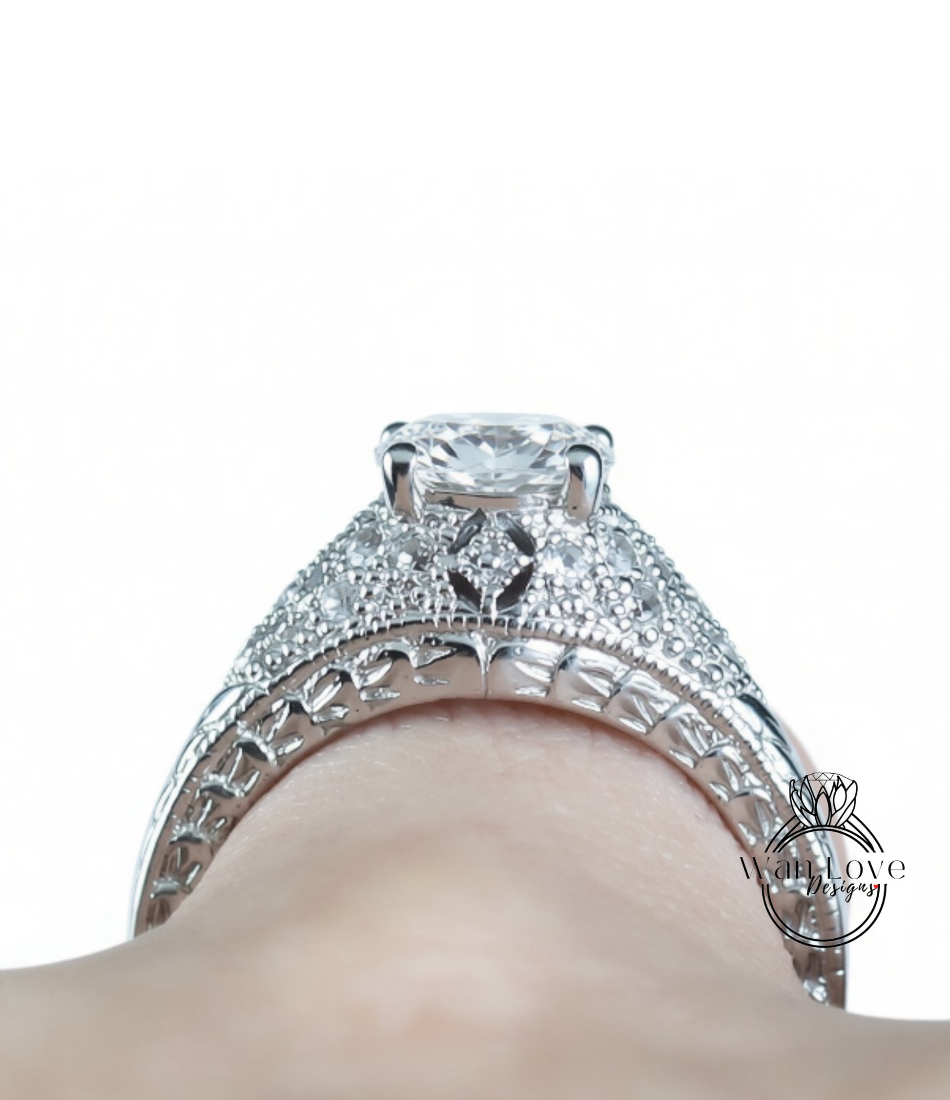 A close-up view of a diamond engagement ring on a person's hand, showcasing the intricate design and sparkling gemstone.