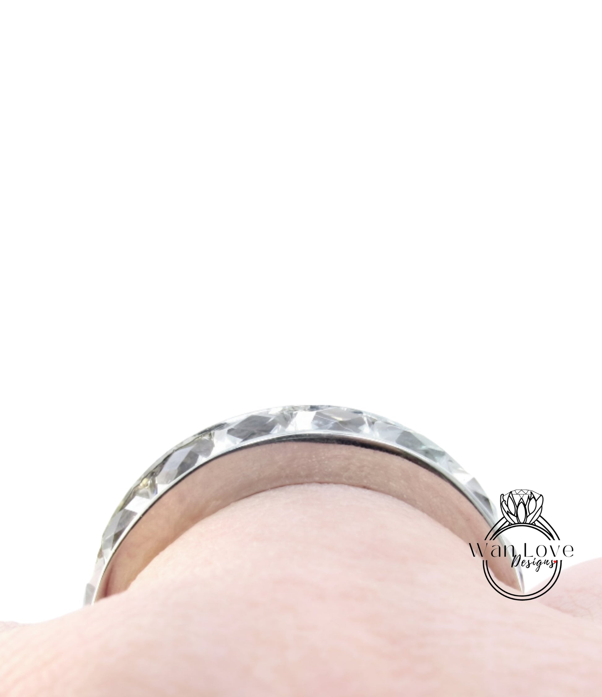 A close-up view of a silver ring on a person's finger.