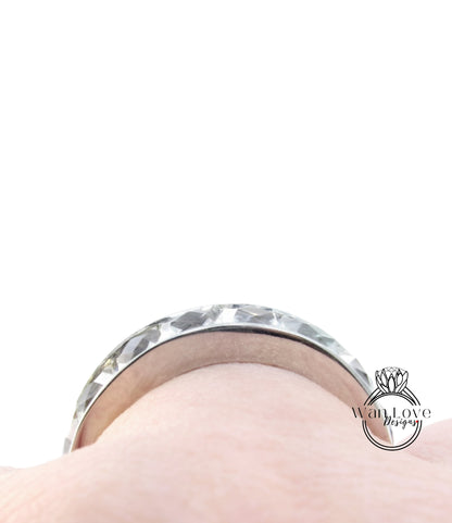 A close-up view of a silver ring on a person's finger.
