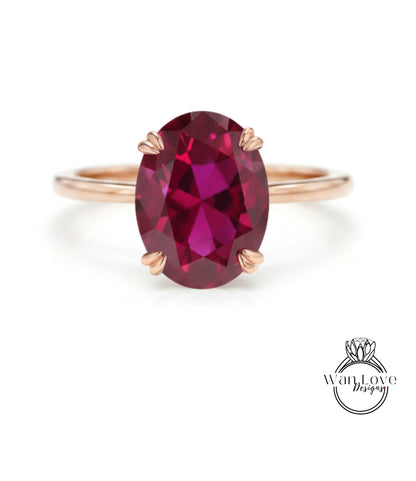 A rose gold ring with a large oval-shaped garnet gemstone set in the center.