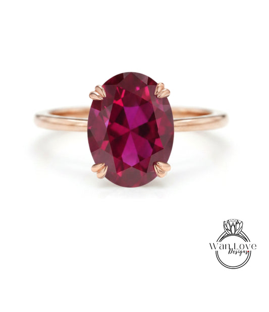 A rose gold ring with a large oval-shaped garnet gemstone set in the center.