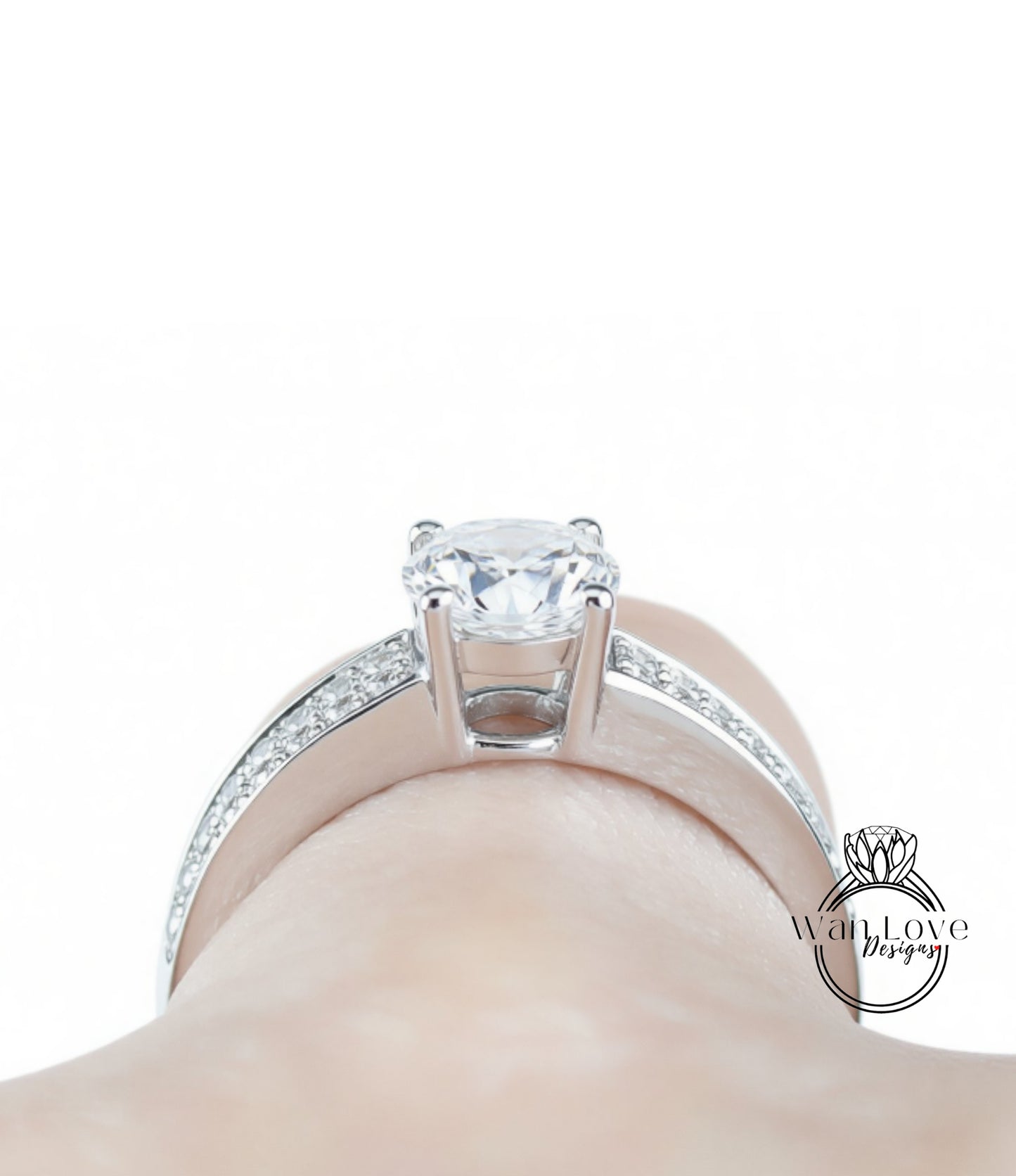 A close-up view of a diamond engagement ring on a person's hand, showcasing the sparkling center stone surrounded by a halo of smaller diamonds set in a silver band.