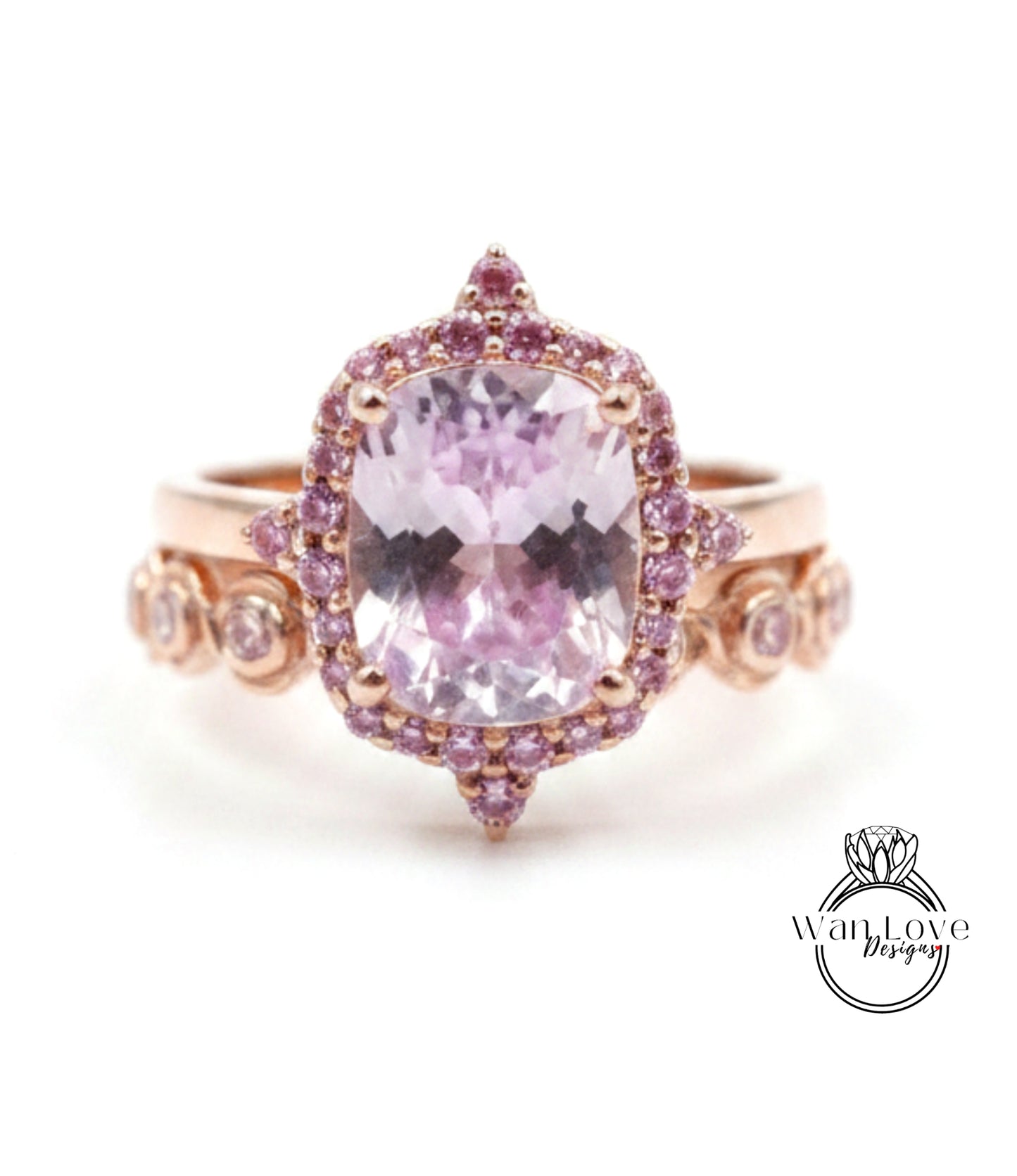 a beautiful pink gemstone ring with a large central gemstone surrounded by smaller gemstones.