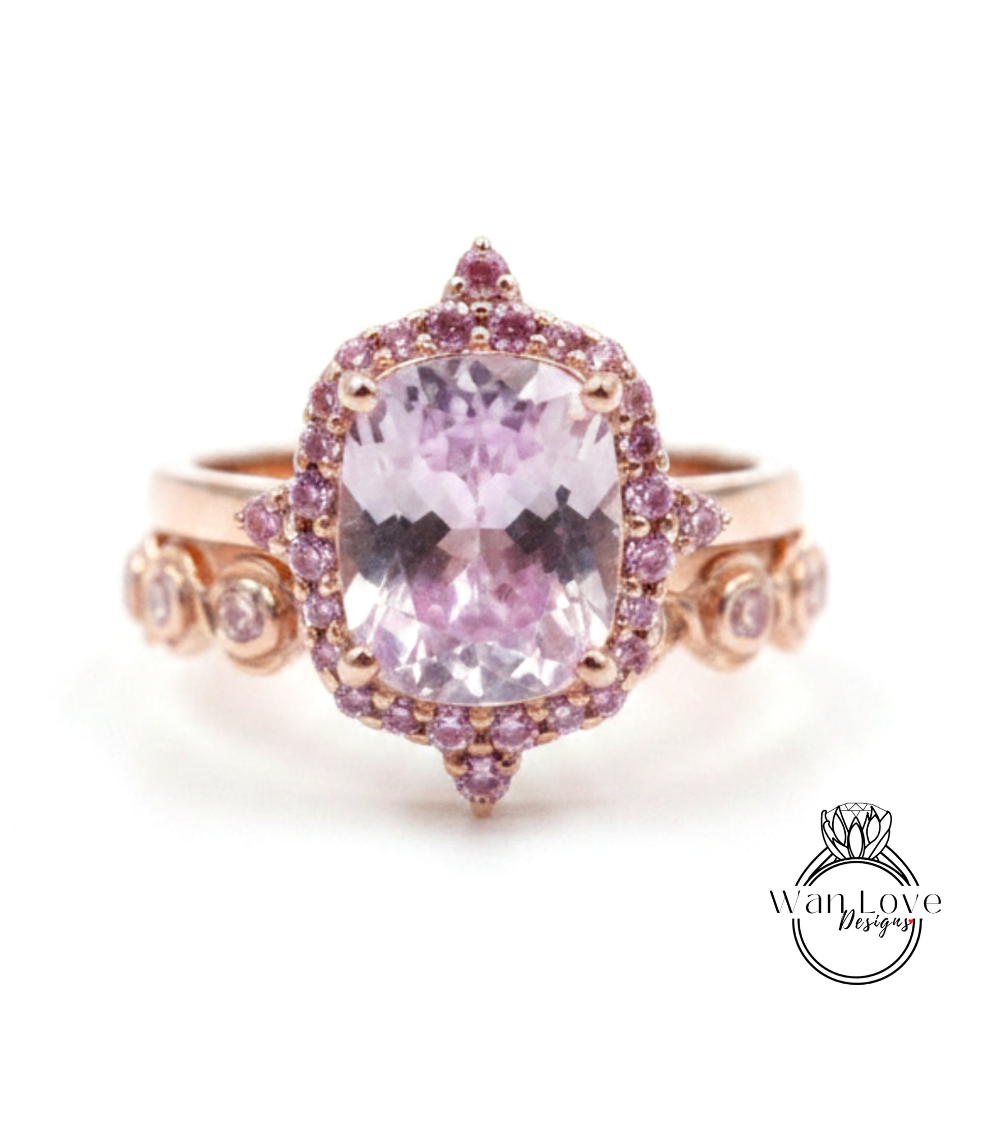 a beautiful pink gemstone ring with a large central gemstone surrounded by smaller gemstones.