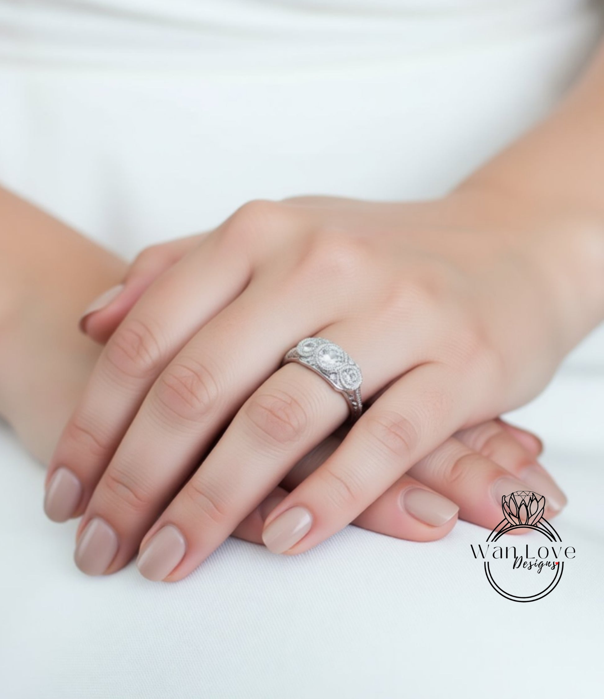 A close-up image of a person's hand wearing a diamond ring.