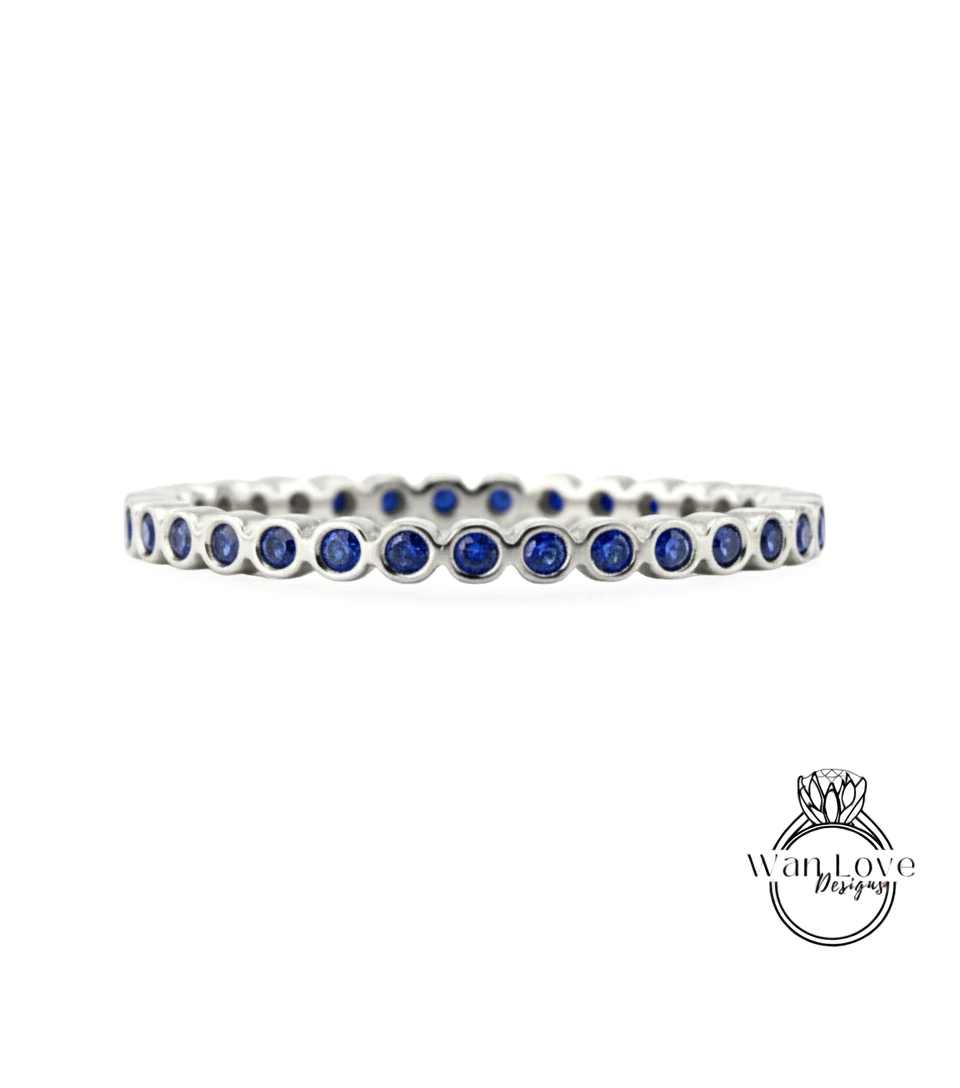 A silver bracelet with blue gemstones arranged in a circular pattern.