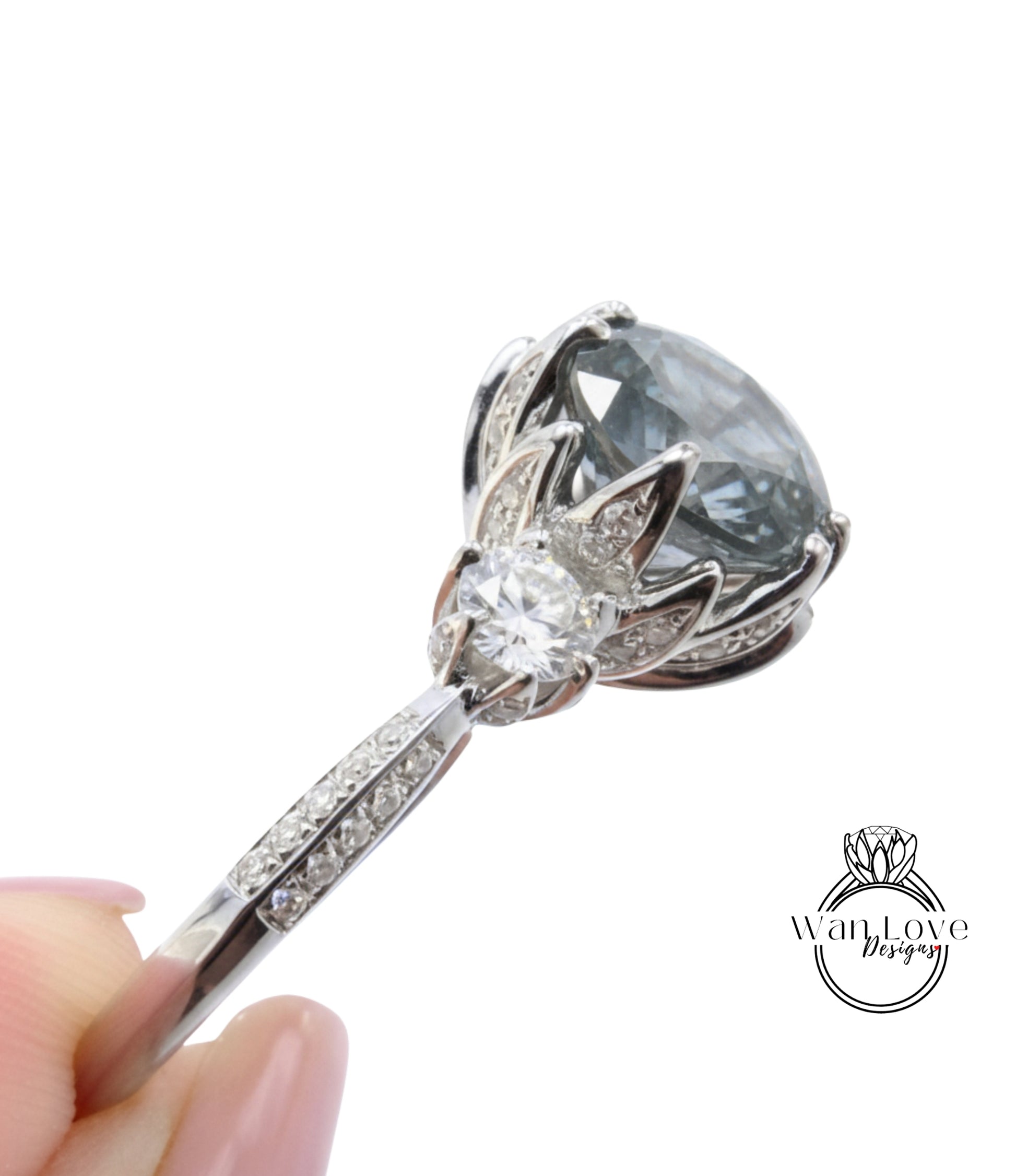 A close-up view of a silver ring with a large, round gemstone, possibly a diamond, set in a decorative metal design.