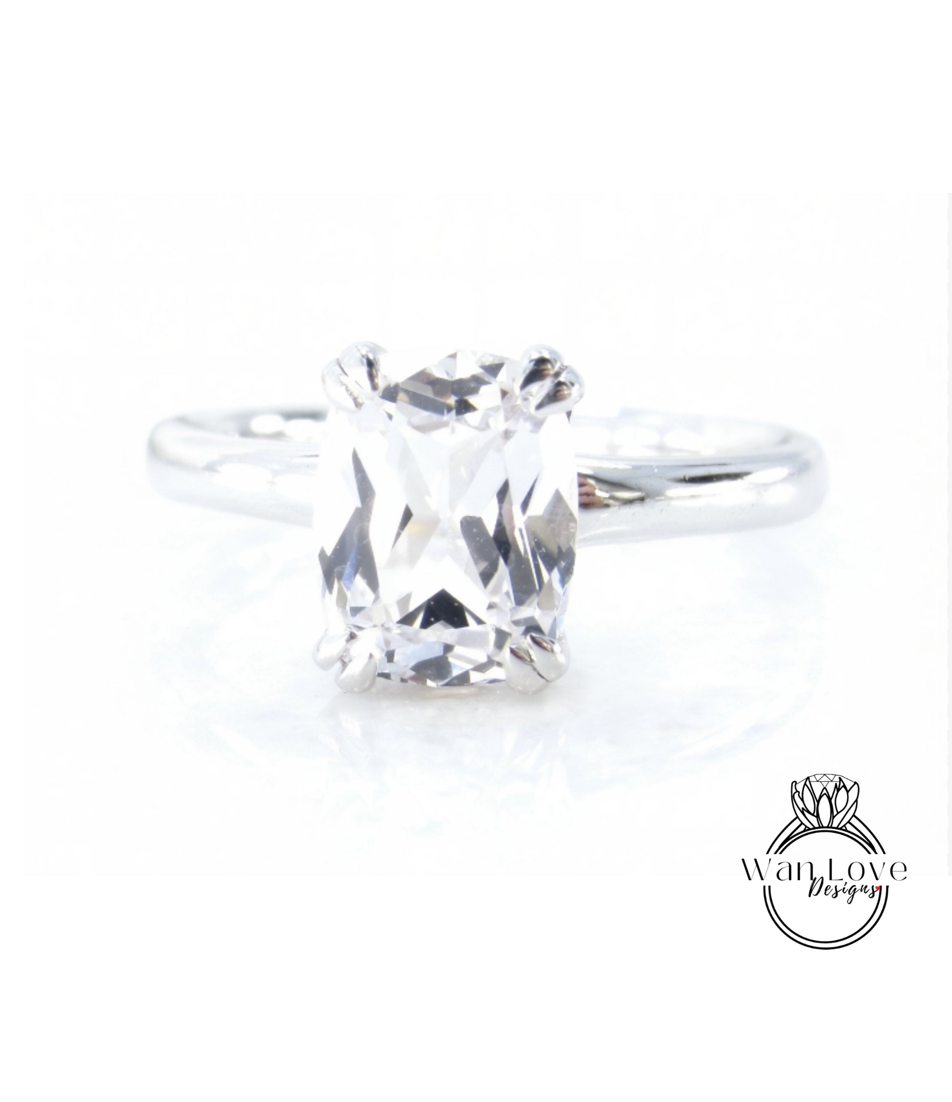 A close-up view of a diamond engagement ring with a large, clear gemstone set in a silver band.