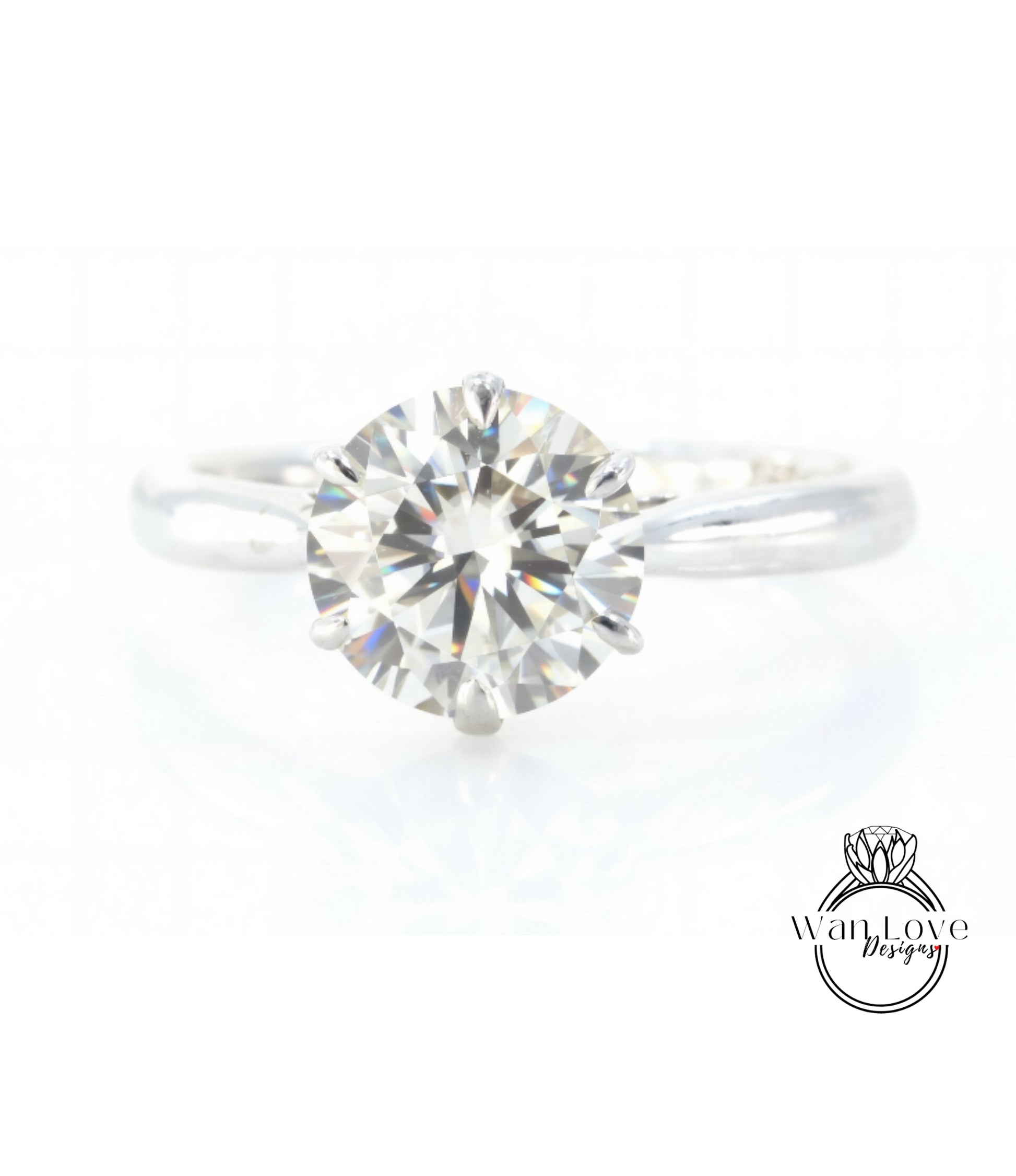 A close-up view of a diamond engagement ring with a large, brilliant-cut diamond set in a silver band.