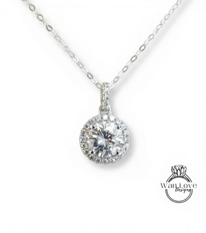 A close-up view of a delicate necklace with a large, round diamond pendant.