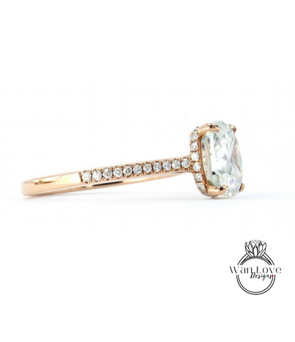 A gold ring with a large oval-shaped gemstone, possibly a diamond, set in the center.