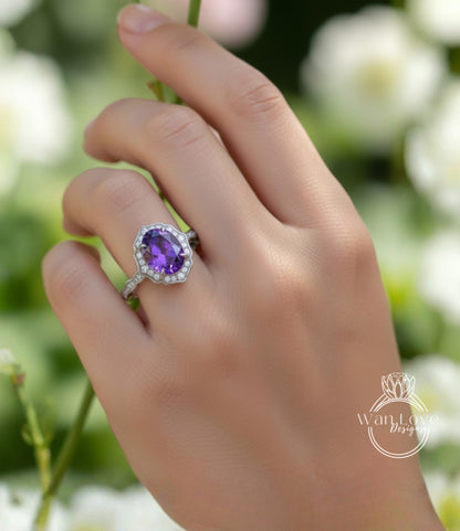 A close-up of a hand wearing a ring with a large purple gemstone, set in a silver band.