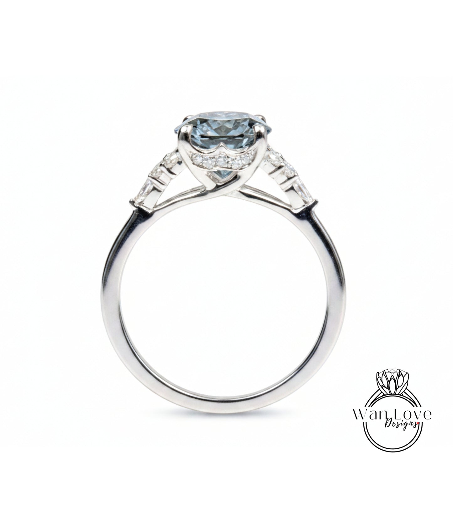 A silver engagement ring with a large blue gemstone set in the center, surrounded by smaller diamonds.
