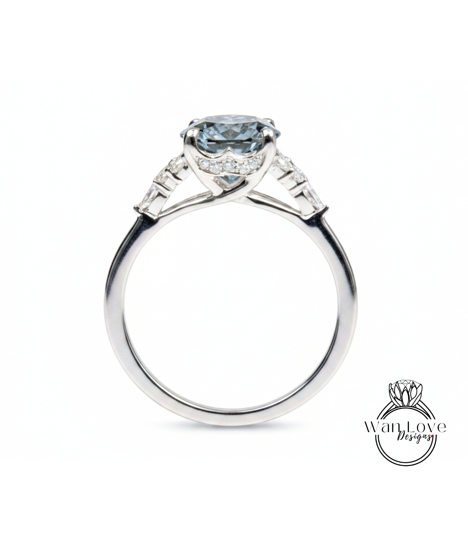 A silver engagement ring with a large blue gemstone set in the center, surrounded by smaller diamonds.