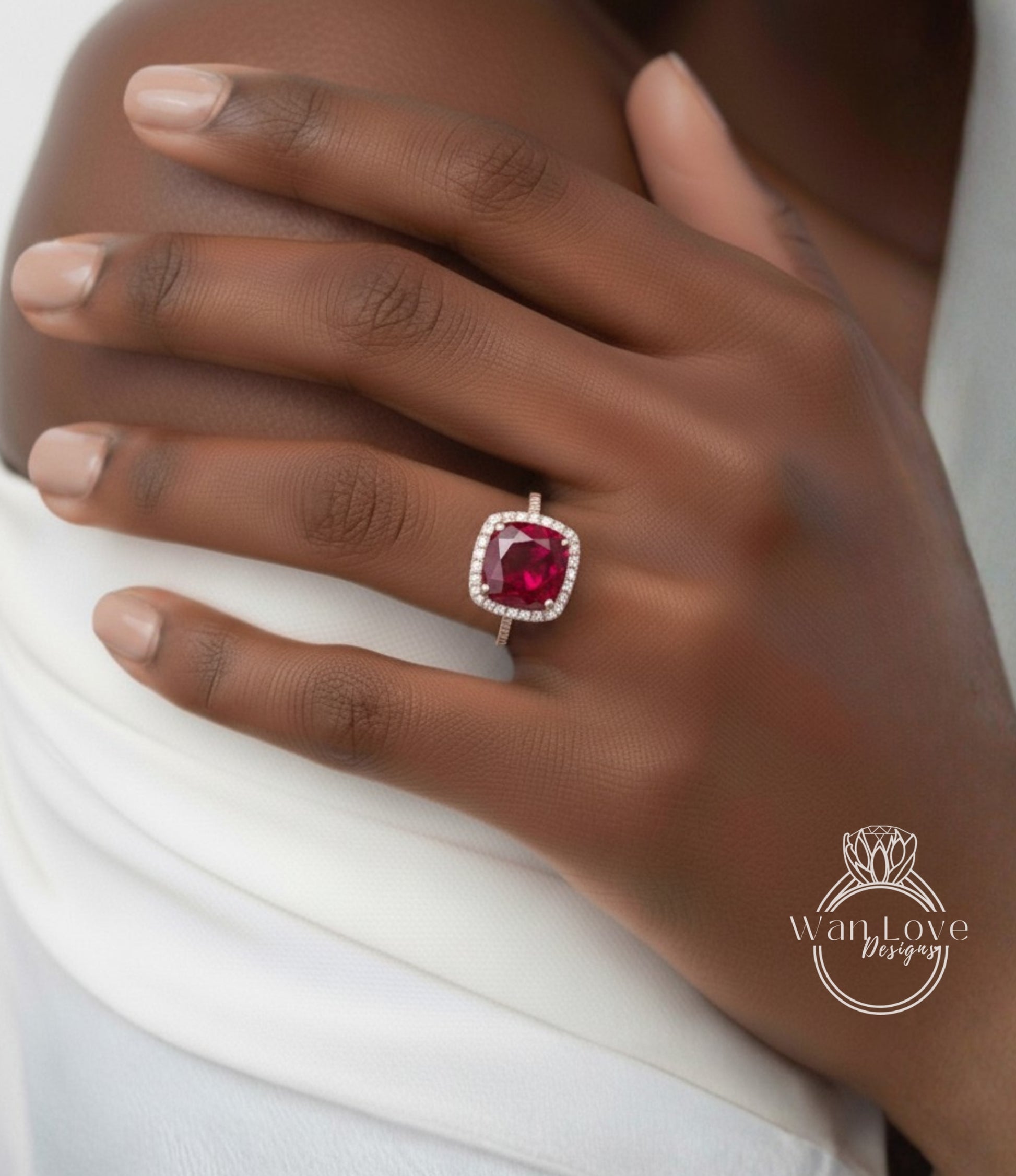 A close-up of a person's hand wearing a ring with a large, red gemstone.