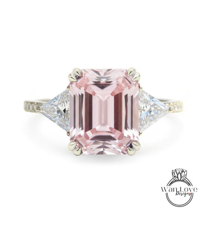 A pink gemstone engagement ring with a diamond-encrusted band.