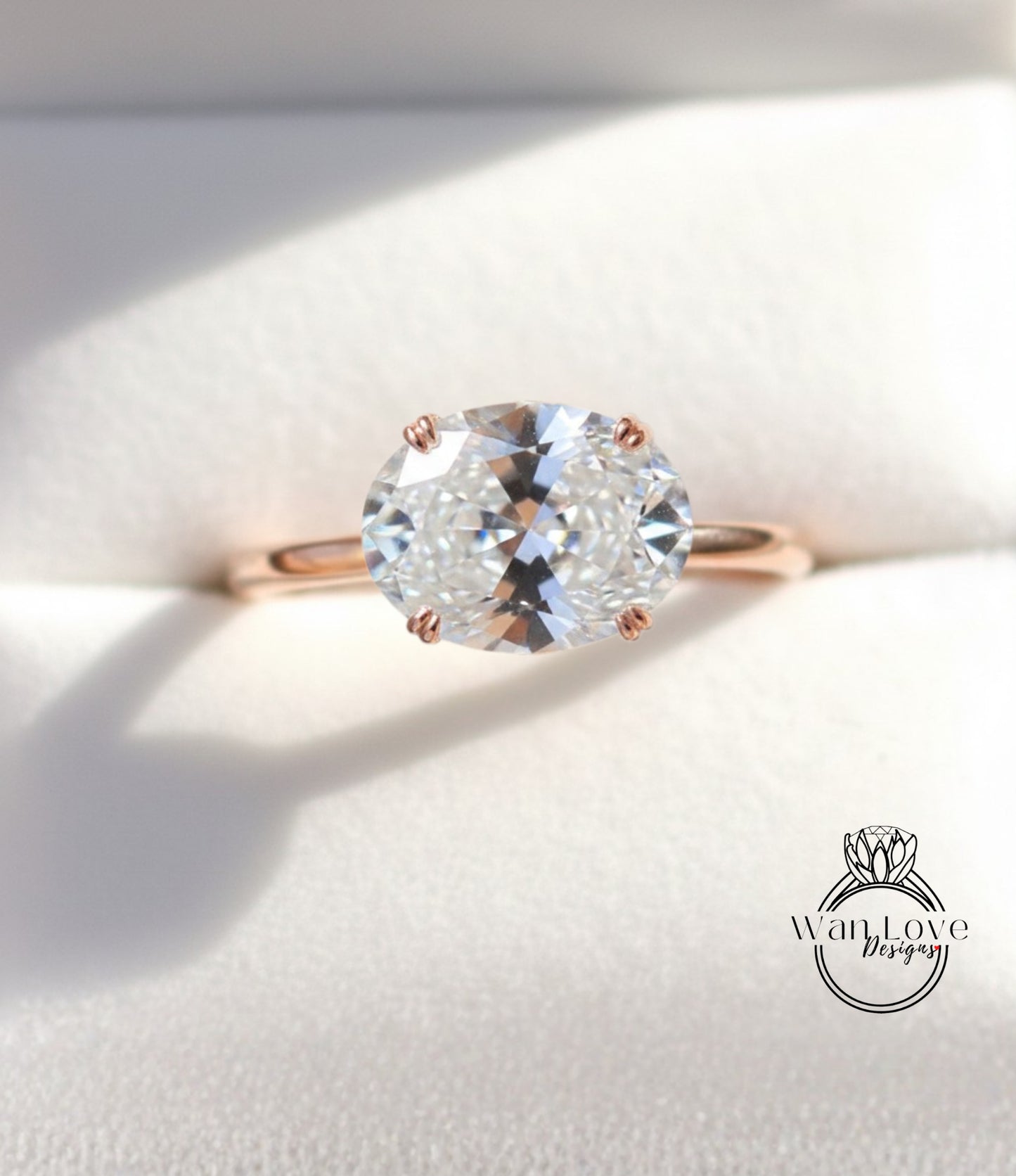 A close-up view of a diamond engagement ring with a large, clear gemstone set in a rose gold band.