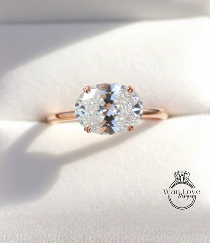 A close-up view of a diamond engagement ring with a large, clear gemstone set in a rose gold band.