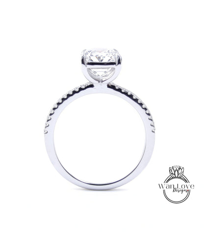 A close-up view of a diamond engagement ring with a large central diamond and smaller diamonds around the band.