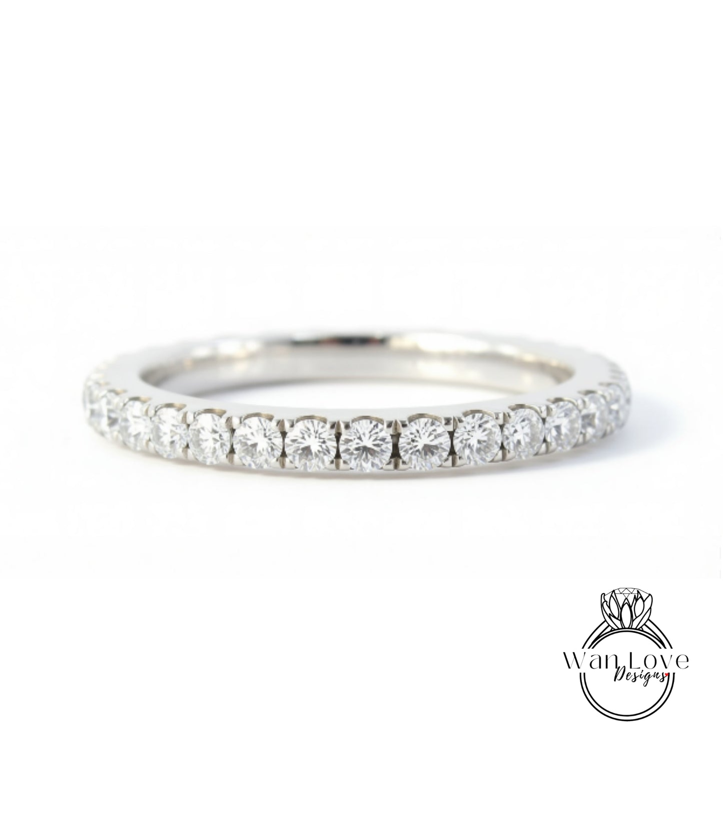 A silver band ring with a row of diamonds set in it.