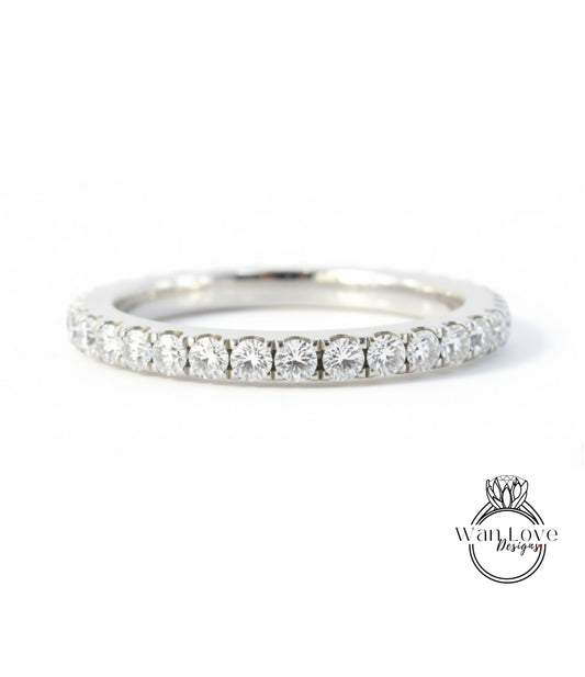A silver band ring with a row of diamonds set in it.