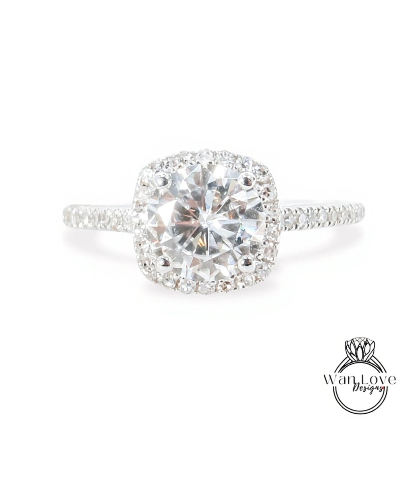 A stunning diamond engagement ring with a large, brilliant-cut diamond set in a halo of smaller diamonds, surrounded by a halo of smaller diamonds on the band.