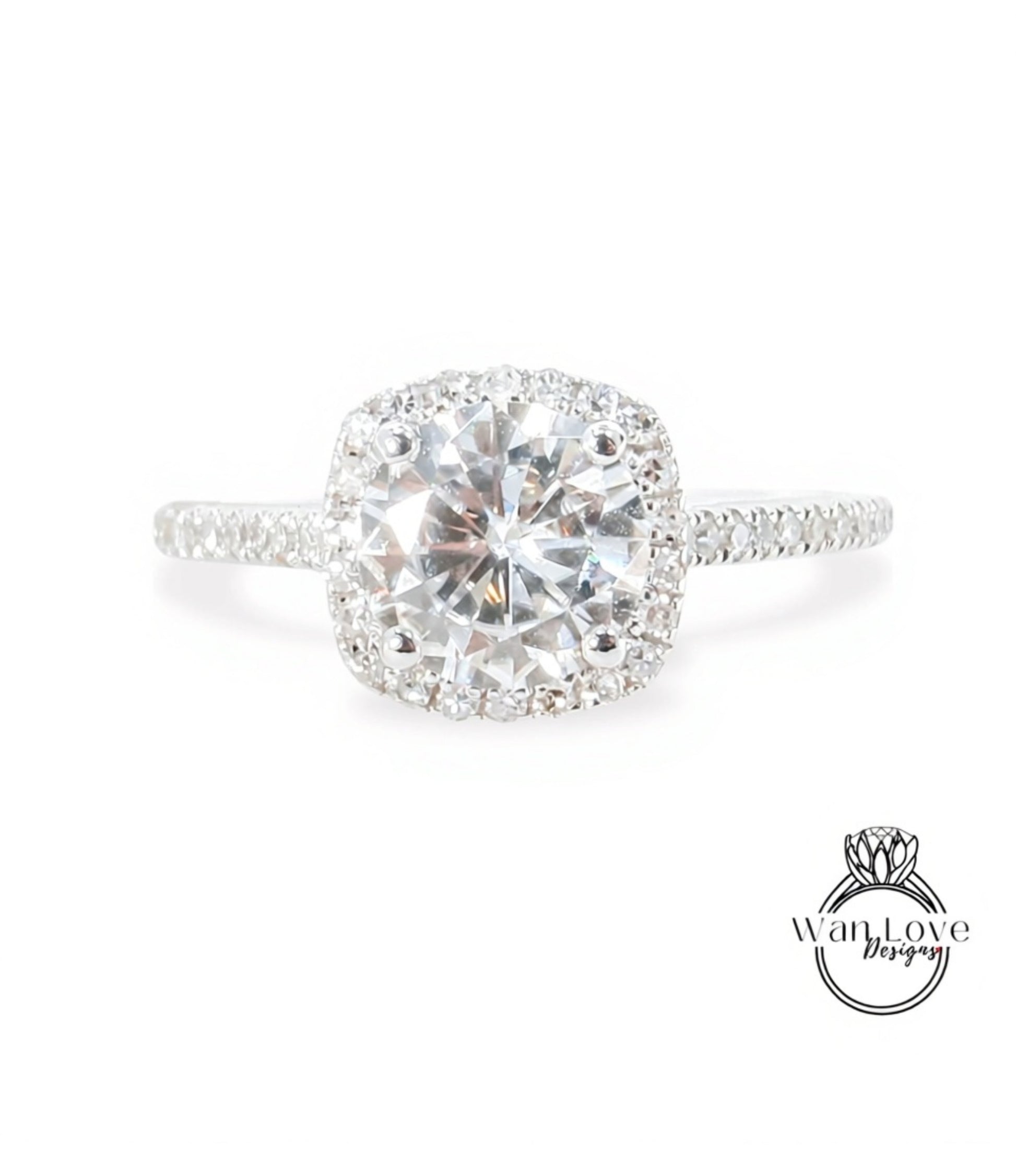 A stunning diamond engagement ring with a large, brilliant-cut diamond set in a halo of smaller diamonds, surrounded by a halo of smaller diamonds on the band.