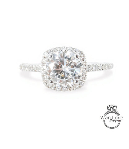 A stunning diamond engagement ring with a large, brilliant-cut diamond set in a halo of smaller diamonds, surrounded by a halo of smaller diamonds on the band.