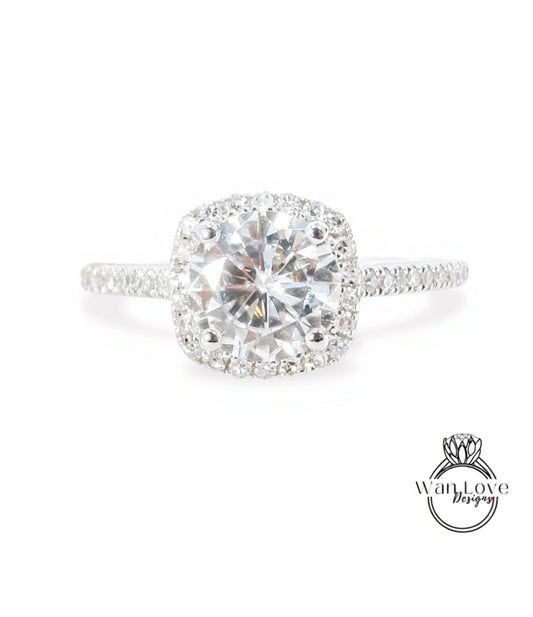A stunning diamond engagement ring with a large, brilliant-cut diamond set in a halo of smaller diamonds, surrounded by a halo of smaller diamonds on the band.