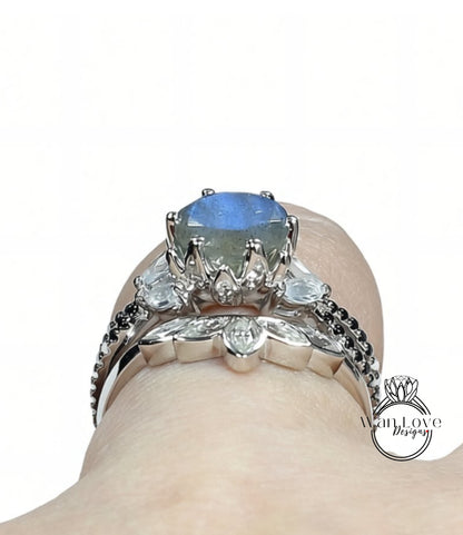 A close-up view of a silver ring with a large blue gemstone, showcasing the intricate design and craftsmanship of the jewelry piece.