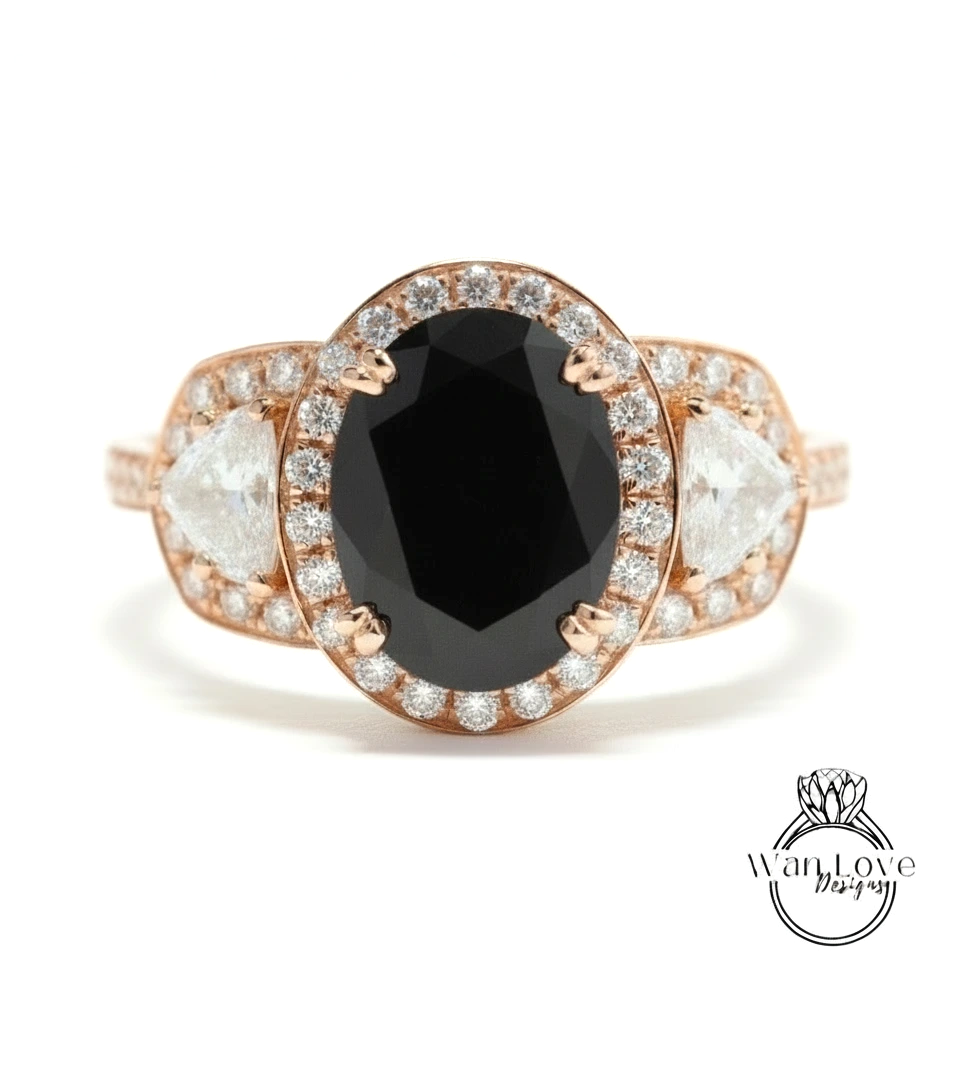 A rose gold ring with a large oval-shaped black gemstone at the center, surrounded by smaller diamonds.