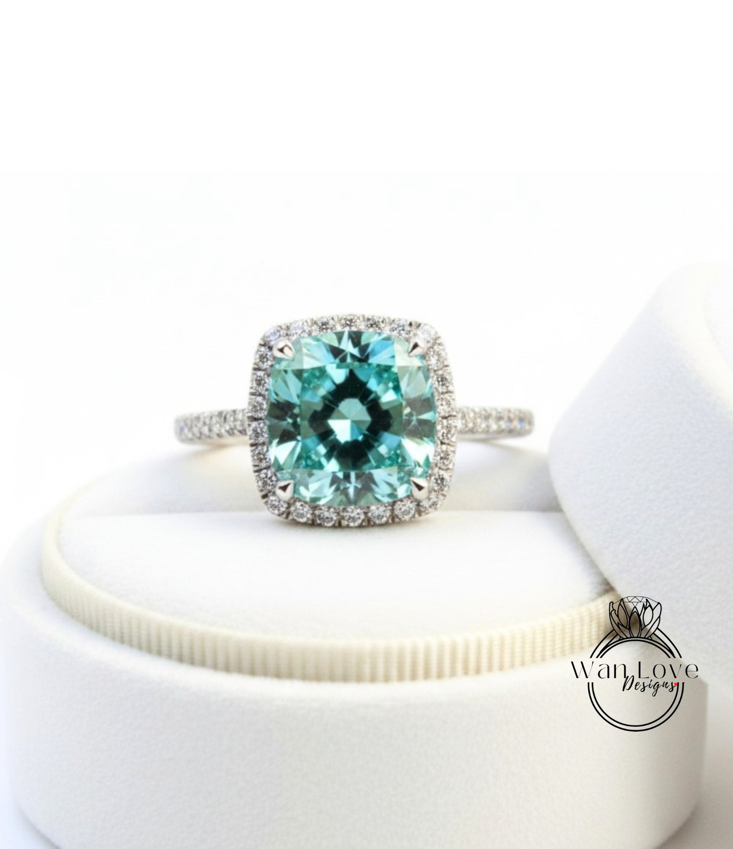 A stunning ring featuring a large, square-cut blue gemstone surrounded by a halo of smaller diamonds, set in a silver band.