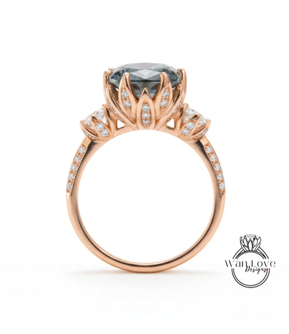 A rose gold engagement ring with a large blue gemstone set in a decorative floral design.