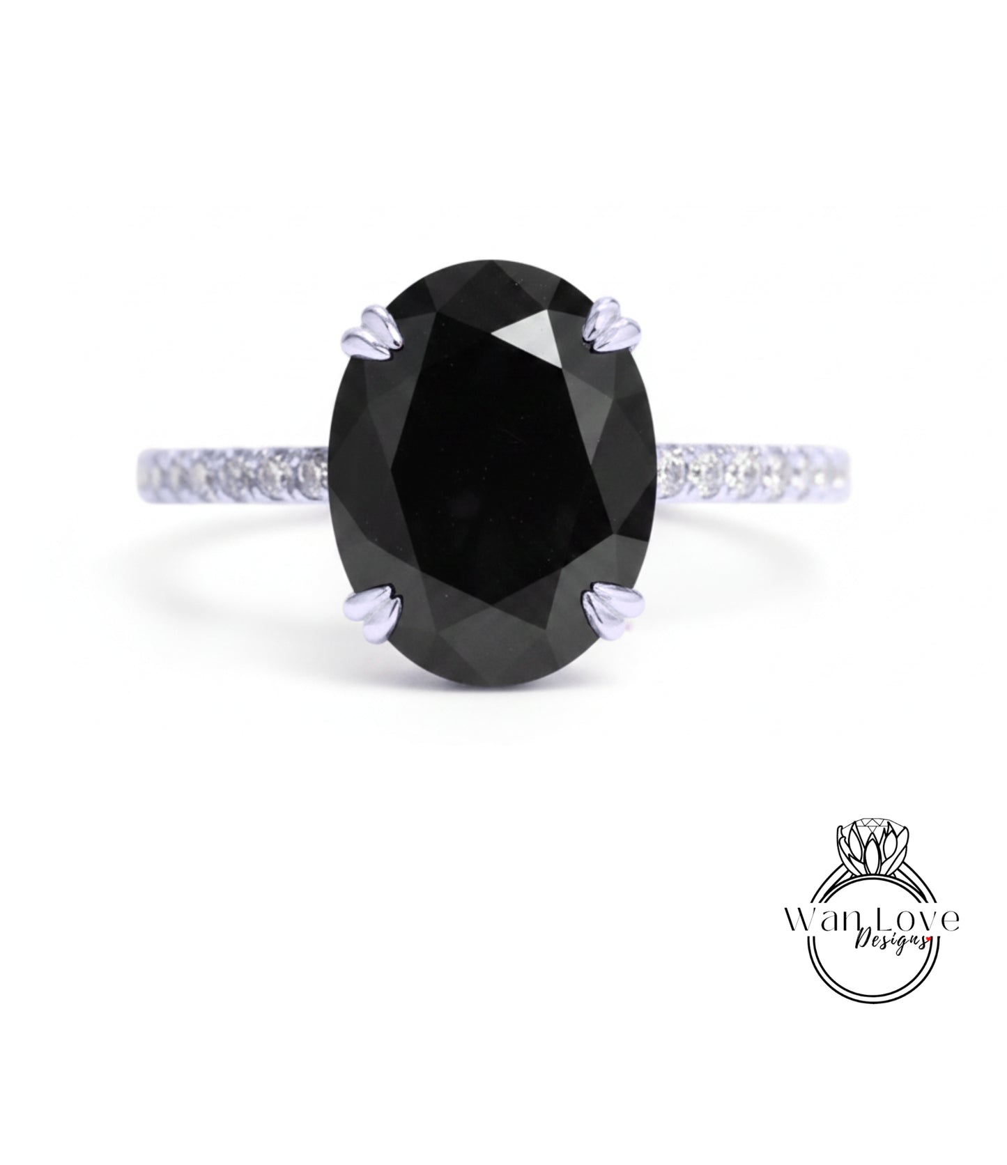 A large oval-shaped black diamond engagement ring with a silver band and small diamonds around the edges.