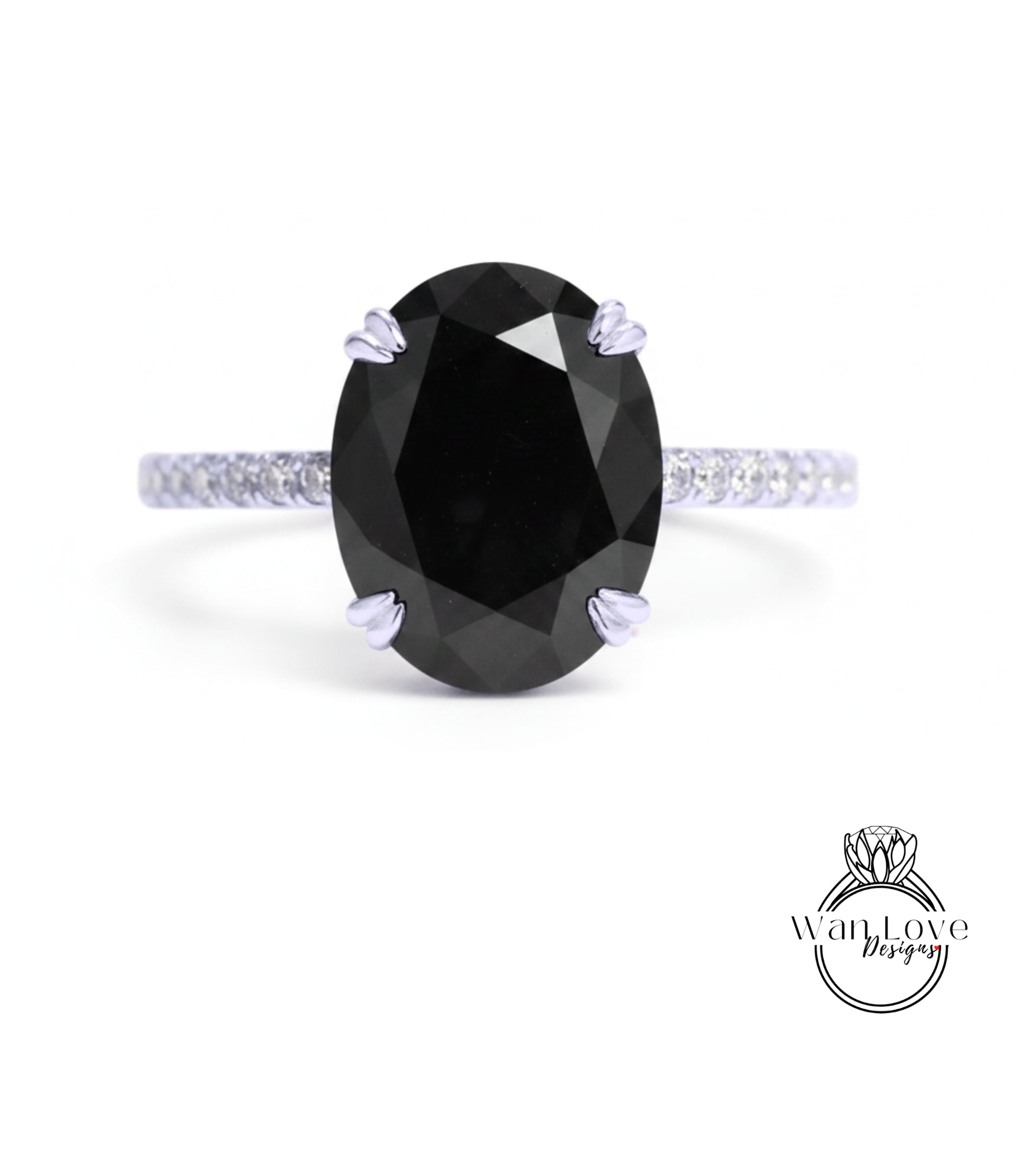 A large oval-shaped black diamond engagement ring with a silver band and small diamonds around the edges.