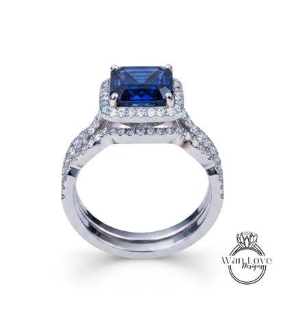 A silver ring with a large blue gemstone, likely a sapphire, set in a halo of smaller diamonds.