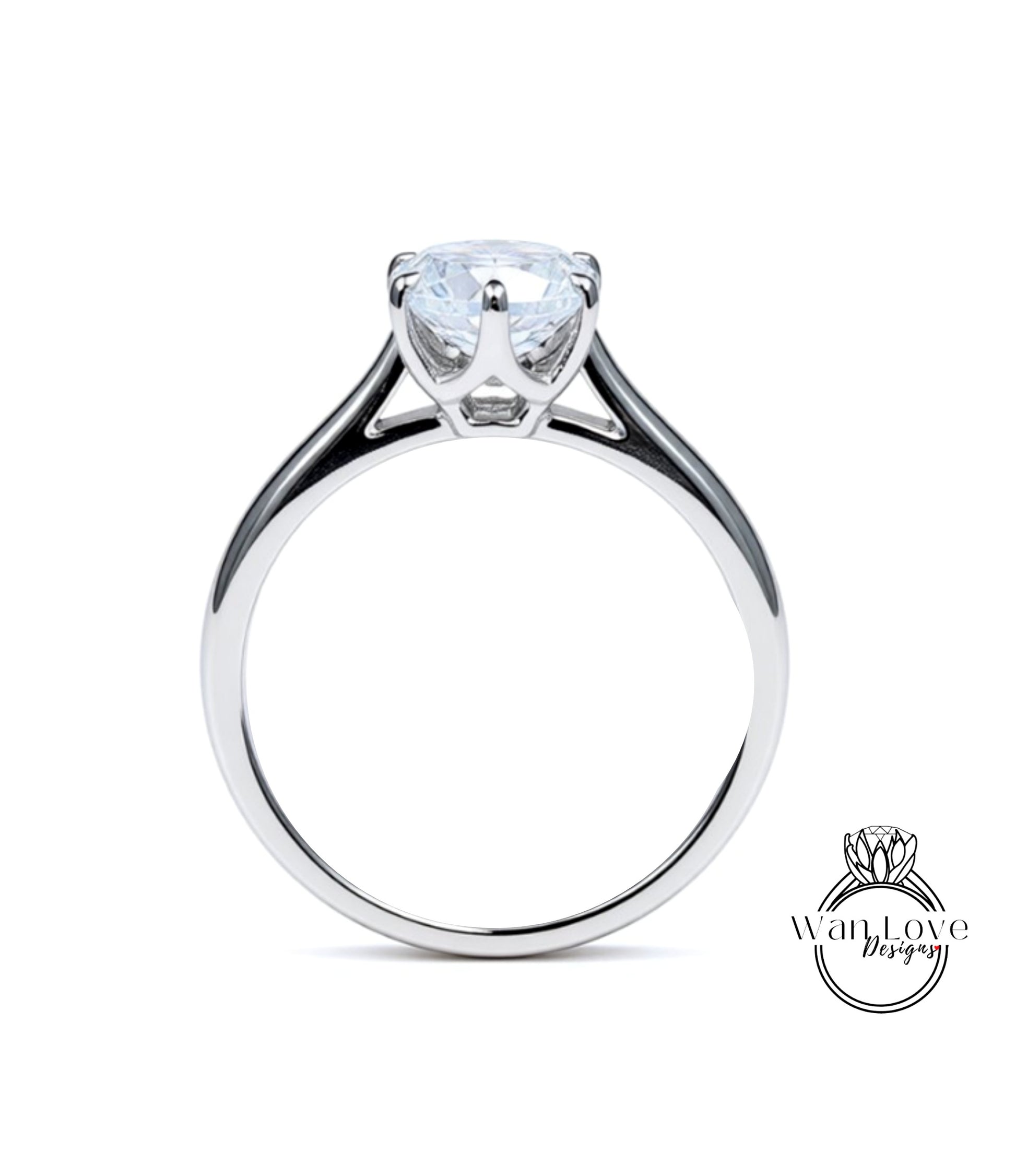 A silver engagement ring with a large, clear gemstone set in the center of the band.