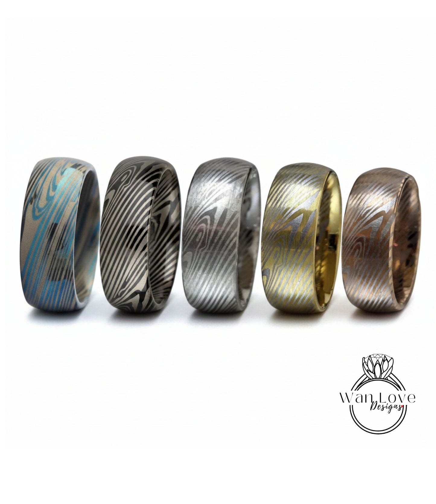 a collection of five rings with unique designs, arranged in a row against a white background.