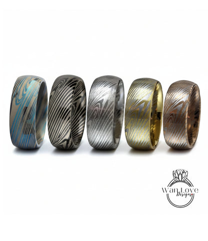 a collection of five rings with unique designs, arranged in a row against a white background.