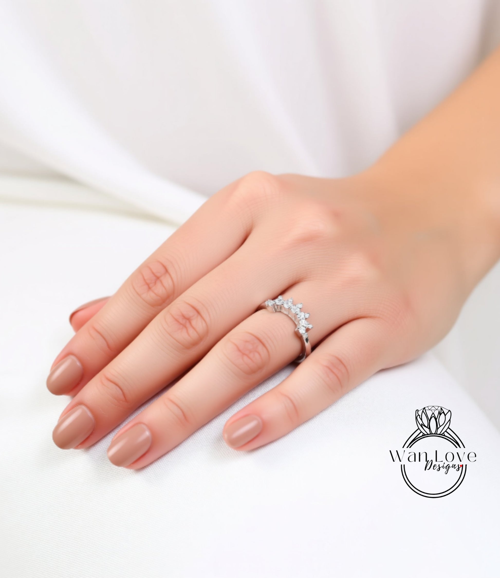 A close-up of a hand wearing a diamond ring on the ring finger.