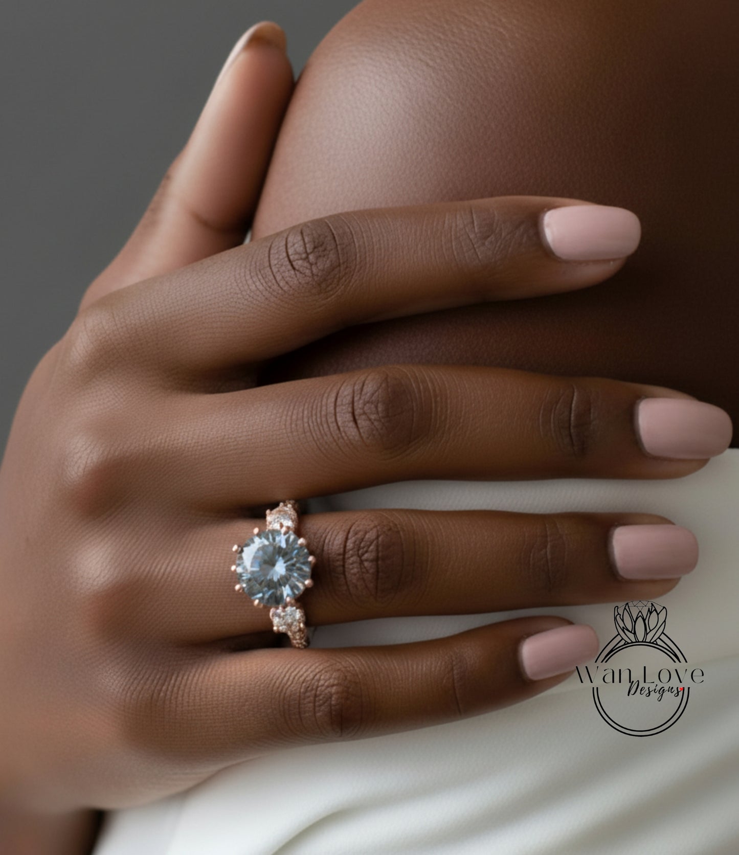 A close-up of a hand wearing a large, ornate ring with a blue gemstone.