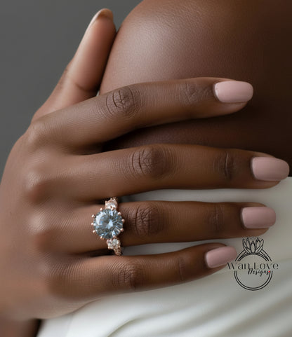 A close-up of a hand wearing a large, ornate ring with a blue gemstone.