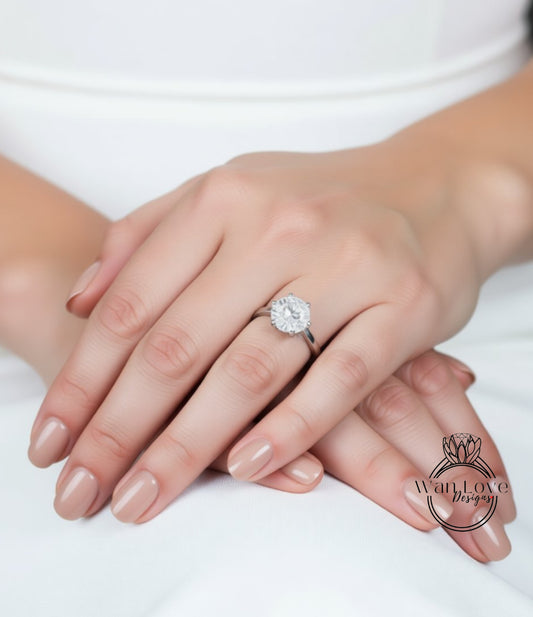 A close-up of a person's hands wearing a diamond engagement ring.